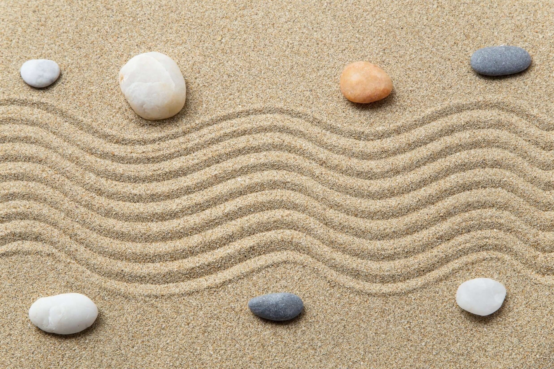 Zen garden with pebbles and raked sand, representing the harmonious mind success connection and subconscious potential.