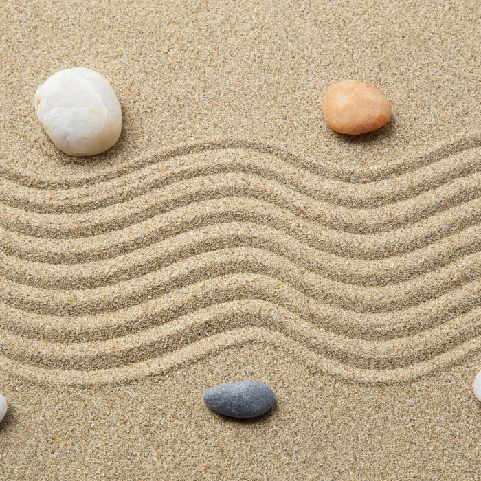 Zen garden with pebbles and raked sand, representing the harmonious mind success connection and subconscious potential.