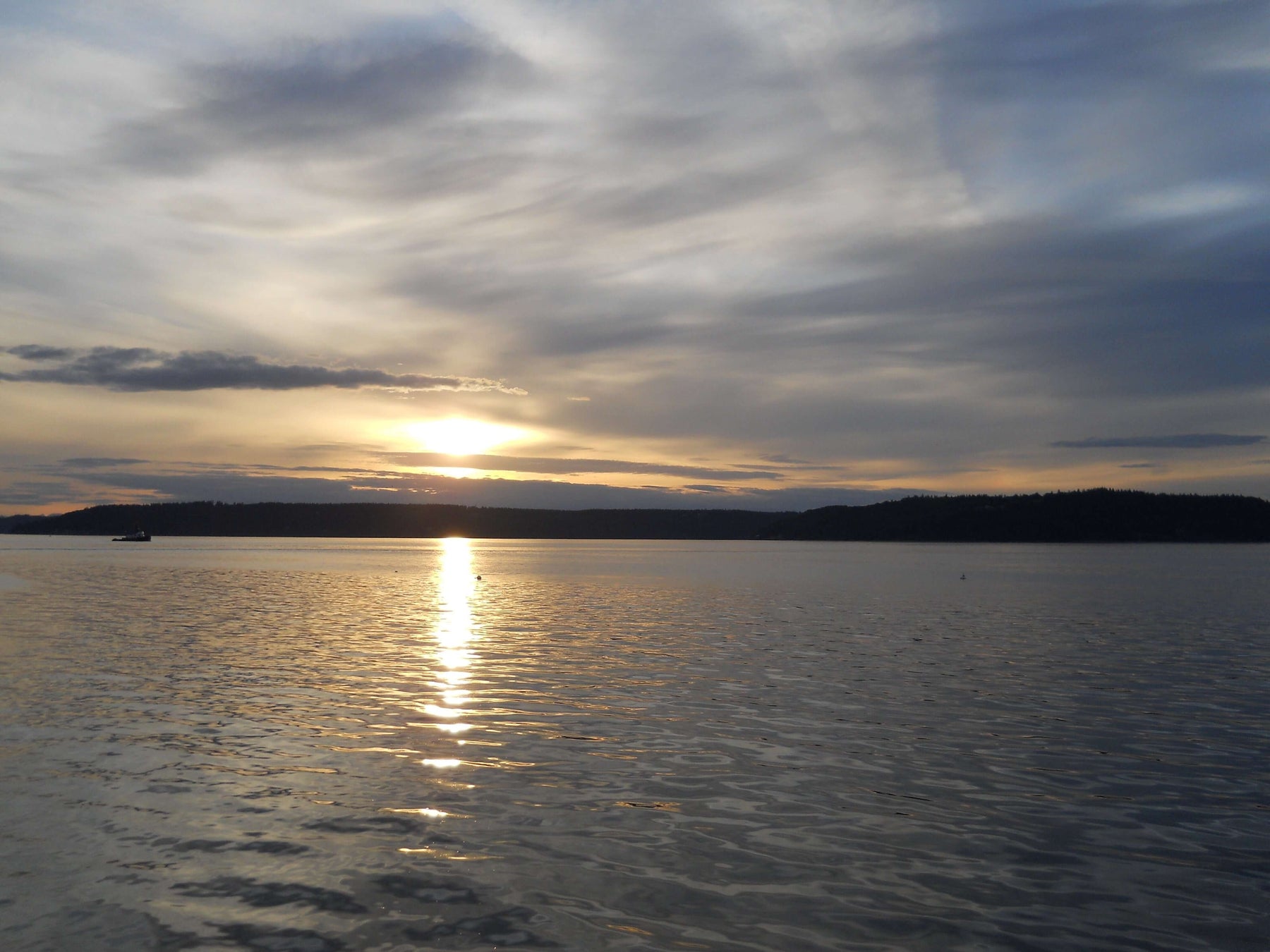 Serene sunset over a calm lake, symbolizing inner peace and personal development in pursuit of happiness.